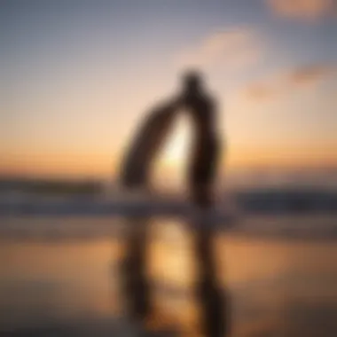 Beginner surfer with foamie board in sunset silhouette