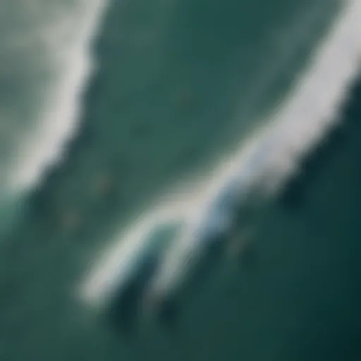 Aerial view of surfers riding waves with a drone capturing the action.