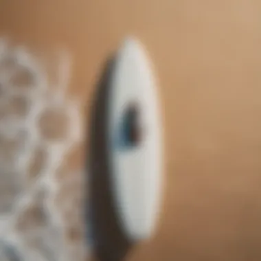 Close-up of a drone hovering over a surfboard at the beach.