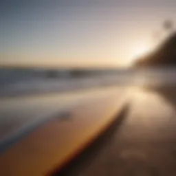 Surfboard on the beach with waves in the background