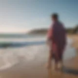 Innovative surfboarding changing poncho hanging on a beach fence