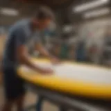 Craftsman shaping surfboard foam