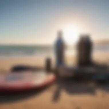 Surf accessories laid out on a sandy beach