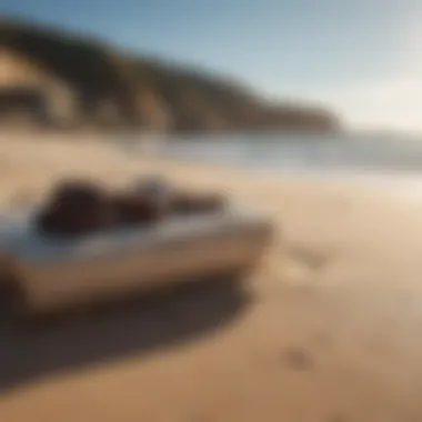 Trendy surf brand clothes laid out on sandy beach