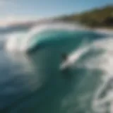 Aerial view of a surfer riding a massive wave at Honolii Beach Park