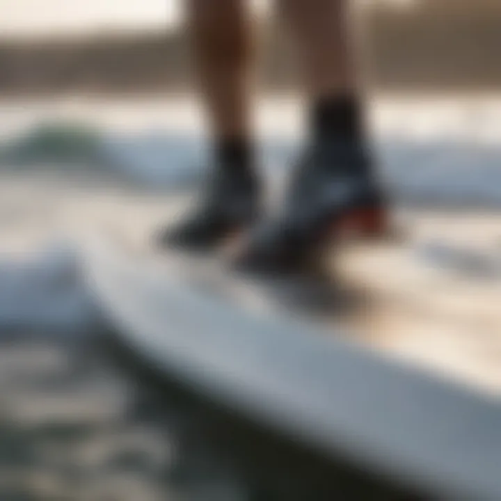 Close-up of a windsurfer adjusting footstraps before hitting the waves