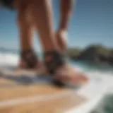 A windsurfer attaching footstraps to a board