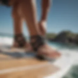 A windsurfer attaching footstraps to a board