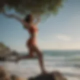 Female practitioner in tree pose by the ocean