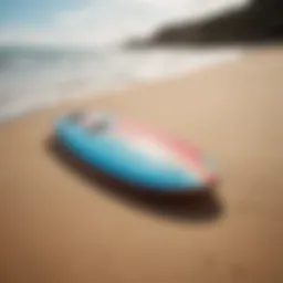 A vibrant skimmer board resting on the sandy beach.