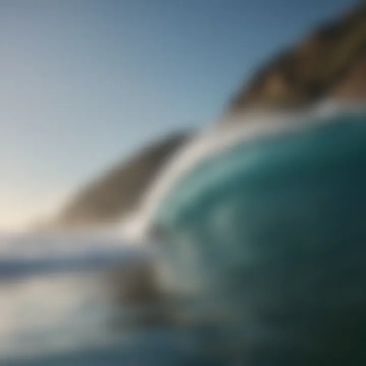 A picturesque coastline with surfers riding waves under a clear blue sky