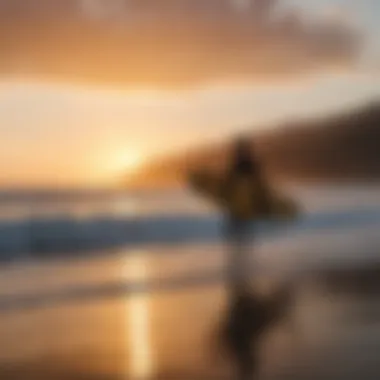 Sunset silhouette of a surfer with a surfboard on an Ecuadorian beach