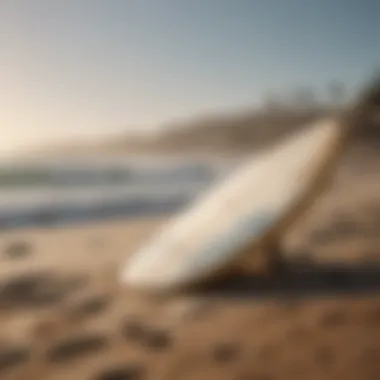 Surfboard placed on sandy beach