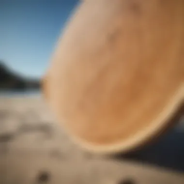 A close-up of a wooden skimboard's underside, highlighting its construction