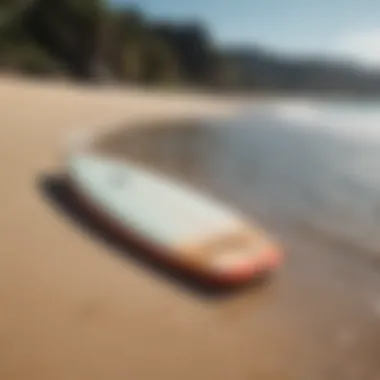 An adult beginner surfboard displayed on a sandy beach with crystal clear water in the background