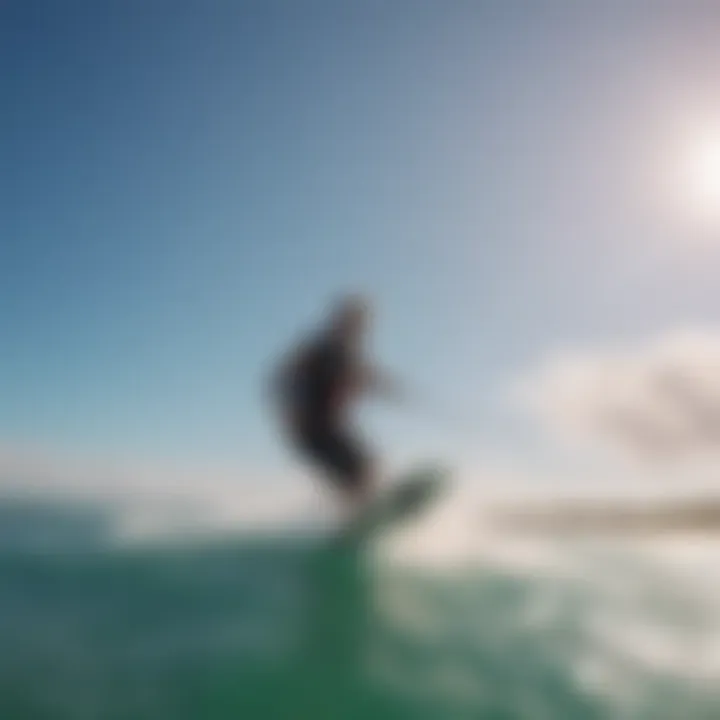 Kitesurfers catching waves under clear blue skies