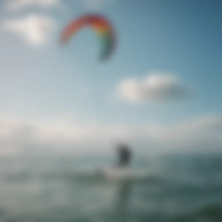 Kitesurfer navigating through crystal clear waters with a colorful kite above