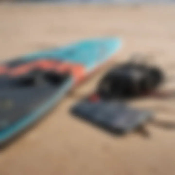 Close-up of kitesurfing equipment laid out on a sandy beach