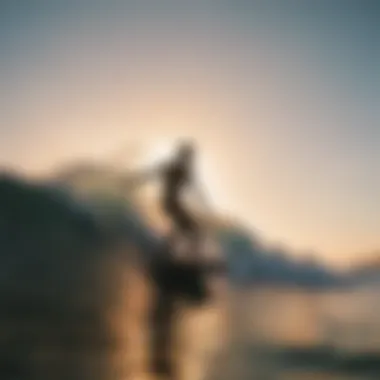 Silhouette of a surfer catching a wave during golden hour