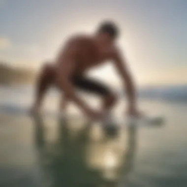 Surfer applying wax in circular motion on the surfboard