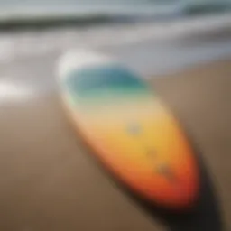 A close-up view of a 7-foot surfboard on the beach, showcasing its sleek design