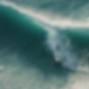 A breathtaking aerial view of surfers catching waves in crystal clear waters