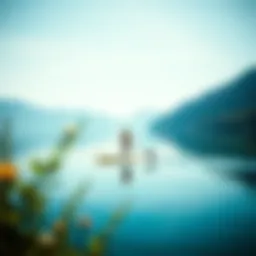 A serene lake landscape with a paddleboarder gliding smoothly across the water