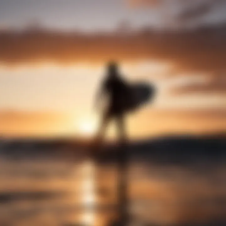 Silhouette of a surfer against a radiant sunset backdrop