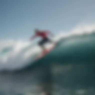 Surfer catching a wave with Red Bull stickered surfboard in action