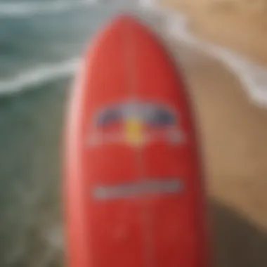 Enhanced Surfboard Design with Red Bull Sticker Close-up of Red Bull sticker on surfboard enhancing its design