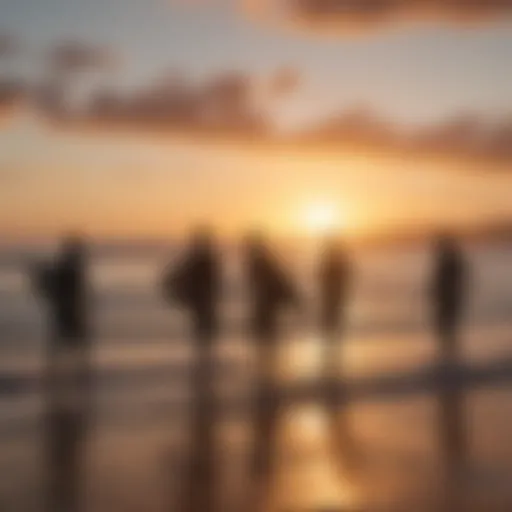 Silhouette of surfers carrying surfboards at sunrise