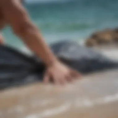 Surfer packing wet gear into IKEA tarp bag