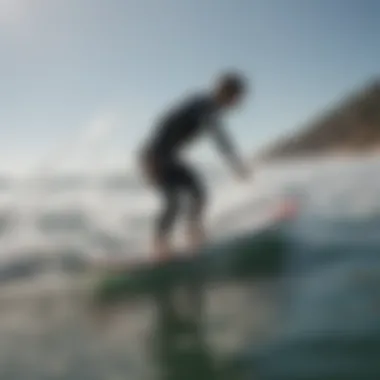 A surfer testing a used foil board in the water, demonstrating its performance capabilities.