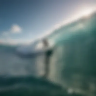 Surfer catching a perfect wave in crystal clear waters of Aruba