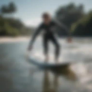 A beginner surfer practicing balance on a surfboard in shallow water