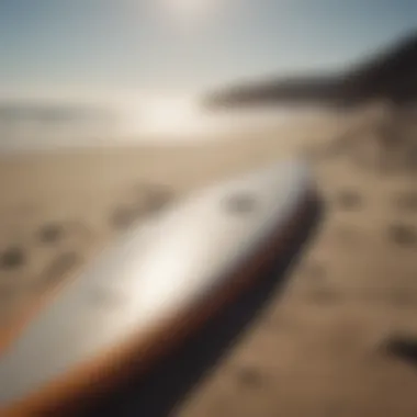 Surfboard laid on sandy beach in San Diego