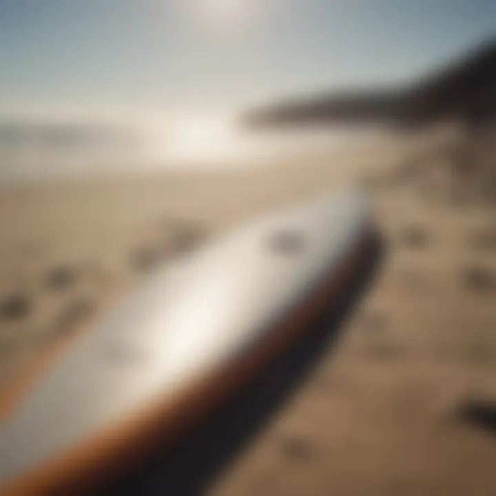 Surfboard laid on sandy beach in San Diego