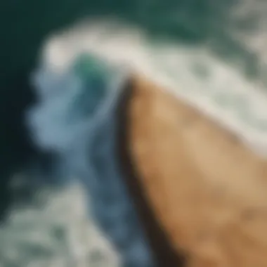 Aerial view of The Wedge surf spot showcasing powerful waves crashing against the shoreline.