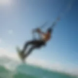 Kiteboarder soaring through the air against a backdrop of clear blue skies