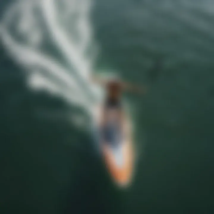 An aerial view of a paddleboarder mastering advanced paddling techniques