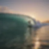 Surfer riding a wave at sunrise