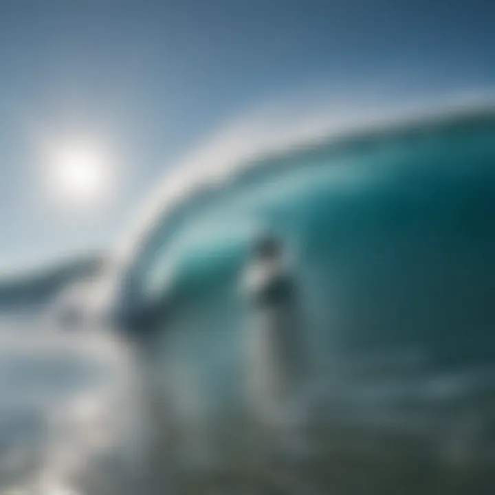 Surfer riding a wave under a clear blue sky